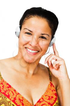 Confident woman listening to music on headphones isolated over white