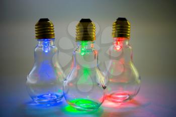 Multi colored light bulbs isolated over white