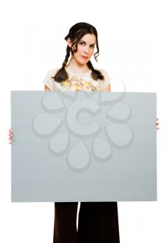 Young woman holding a placard and posing isolated over white