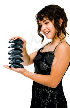 Happy teenage girl holding computer mouses and posing isolated over white