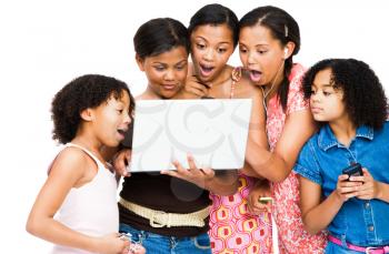 Shocked friends using a laptop isolated over white