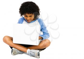 Boy using a laptop and smiling isolated over white