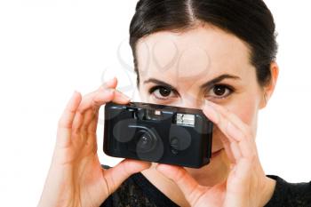 Fashion model photographing with a camera isolated over white
