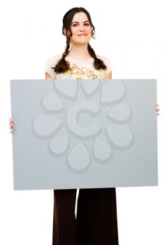 Smiling woman holding a placard and posing isolated over white