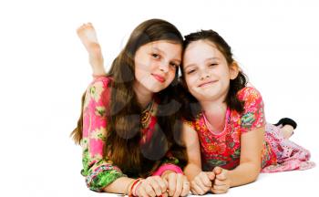Portrait of two girls smiling and posing isolated over white