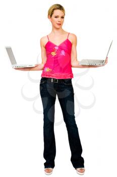 Smiling mid adult woman holding laptops isolated over white