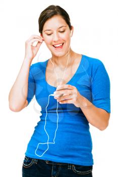 Young woman listening to music on an mp3 player isolated over white