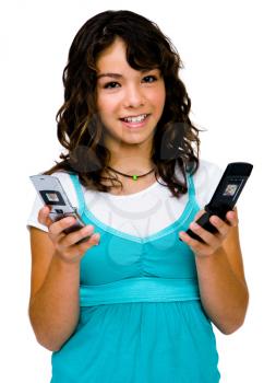 Portrait of a teenage girl text messaging on mobile phones isolated over white