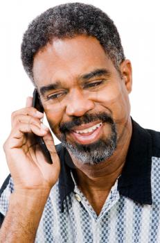 Mature man talking on a mobile phone isolated over white