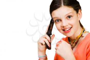 Confident girl talking on a mobile phone isolated over white