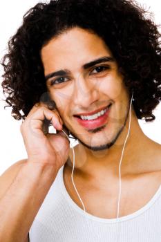 Handsome man listening to music on a MP3 player isolated over white