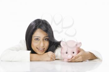 Portrait of a businesswoman with a piggy bank
