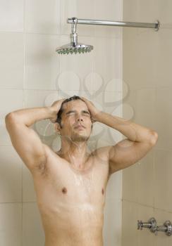 Close-up of a young man taking a shower
