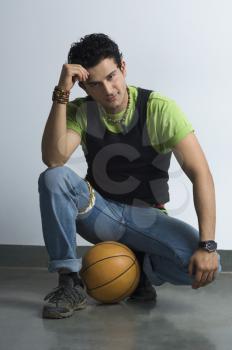 Portrait of a man sitting with a basketball