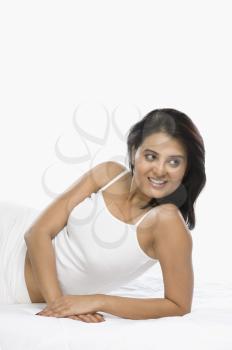 Woman leaning on the bed and smiling