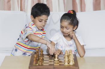 Boy and a girl playing chess