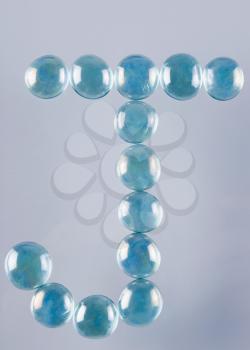 Close-up of marble balls arranged in the shape of letter J