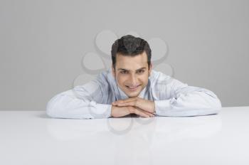 Businessman leaning on a desk