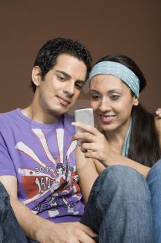 Couple reading a message on a mobile phone