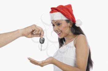 Woman surprised to see car key as a Christmas present