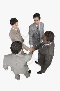 Businessmen stacking hands