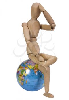 Close-up of an artist's figure sitting on a globe
