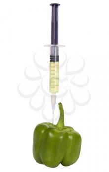 Green bell pepper being injected with a syringe