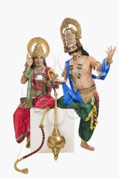Two men dressed-up as Rama and Ravana and drinking tea