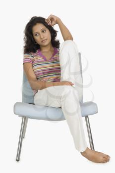 Woman sitting on a chair and looking serious