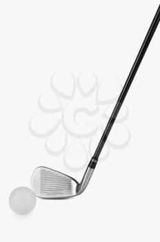 Close-up of a golf club with a golf ball