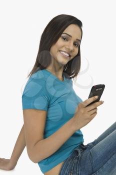 Woman text messaging on a mobile phone