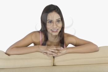 Portrait of a woman leaning on a couch
