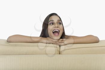 Close-up of a woman leaning on a couch