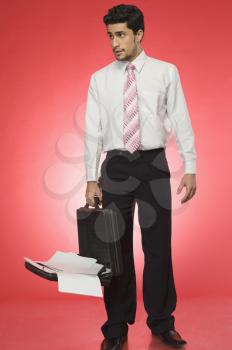 Businessman holding an open briefcase
