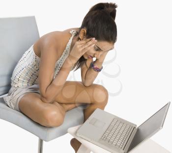 Woman using a laptop and looking disappointed