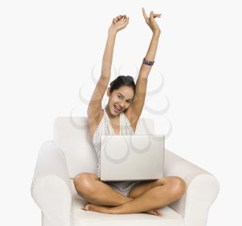 Woman using a laptop and looking excited