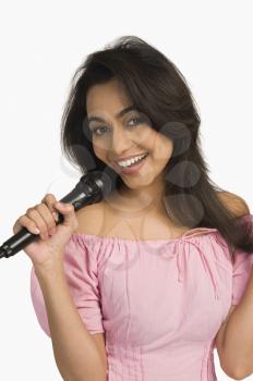 Portrait of a woman singing into a microphone