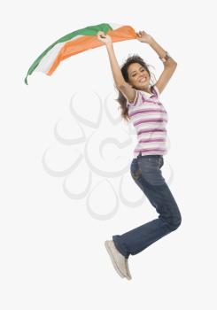 Portrait of a woman jumping with an Indian flag