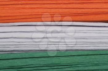 Close-up of a stack of colorful papers representing Indian flag colors