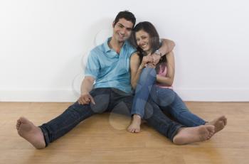 Couple sitting on the floor and smiling