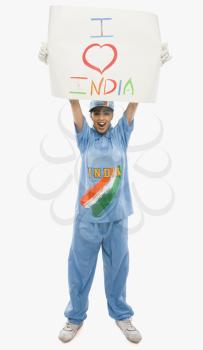 Woman in cricket uniform holding a placard with text I Love India written on it
