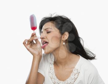 Woman licking ice cream on her hand