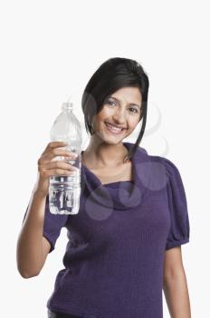 Woman holding a water bottle and smiling