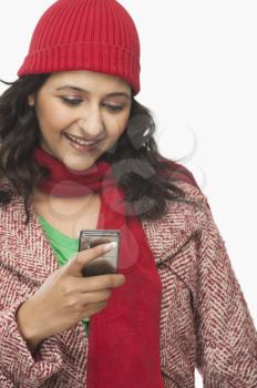Woman reading a message on a mobile phone and smiling