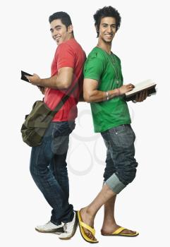 Two university students reading books back to back