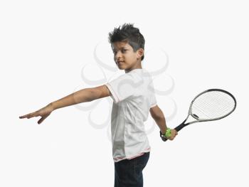 Portrait of a boy playing with a tennis racket