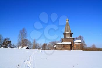 wooden chapel on snow field