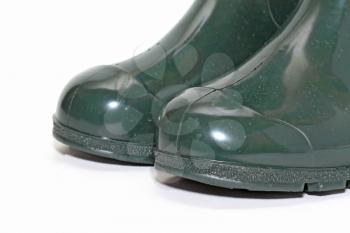 green rubber boots on white background