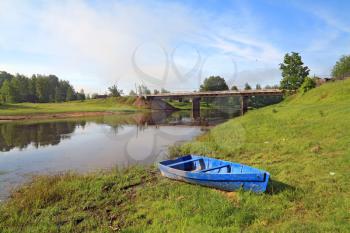 wooden boat on river coast near villages