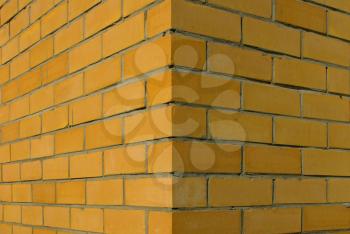 Corner of a brick wall, yellow brick.                    